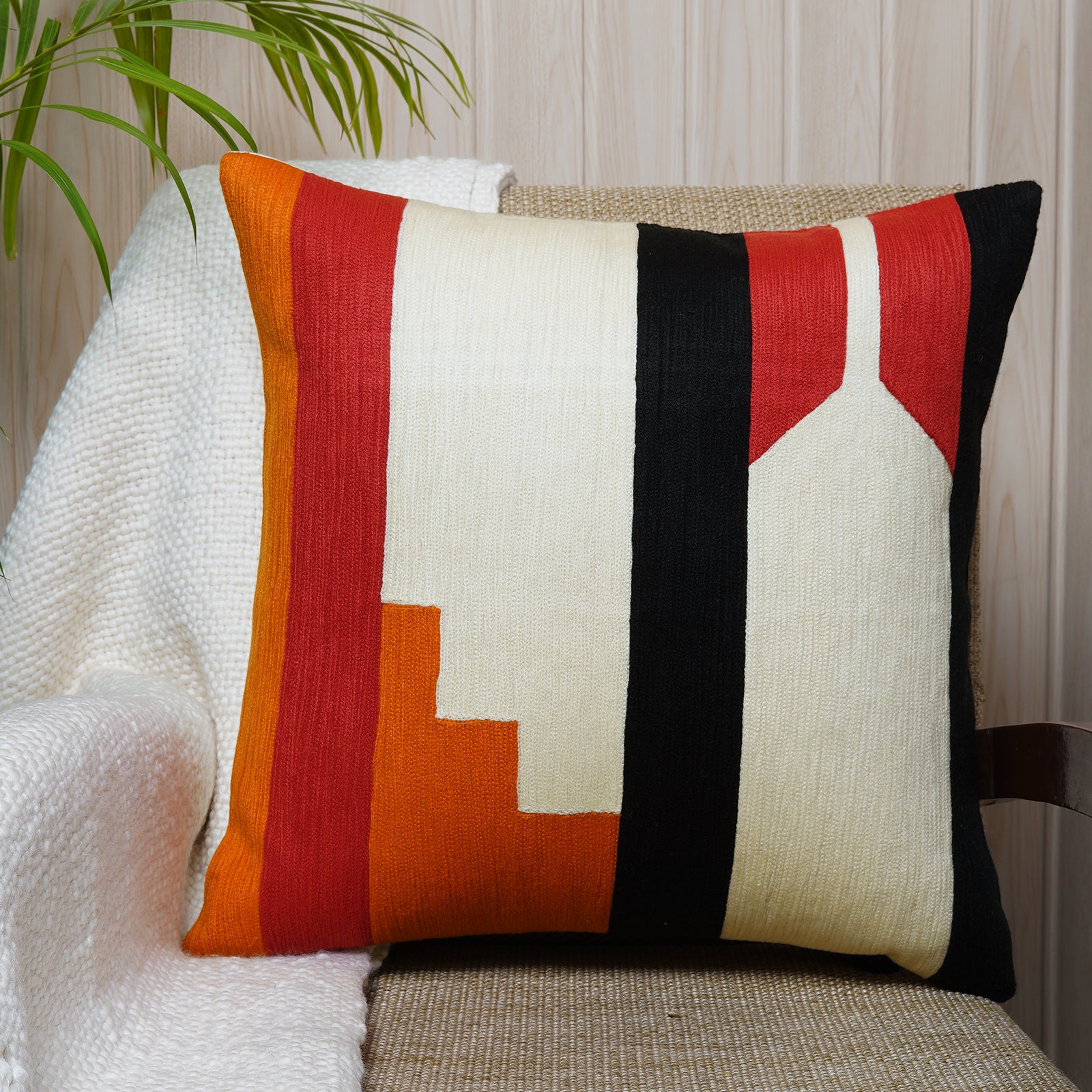 Bold square cushion with geometric embroidery in red, black, mustard, and ivory tones - Bauhaus style